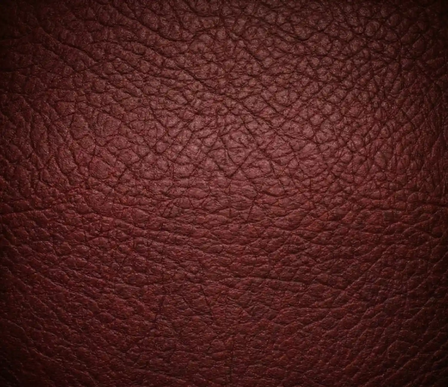 Macro detail of hand-stitched cognac Italian leather saddle bag showing pristine edge burnishing